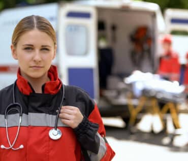 paramedic in front of ambulance - vital role ambulance services play in saving lives